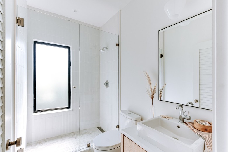 Minimalist bathroom with white shower tile floor